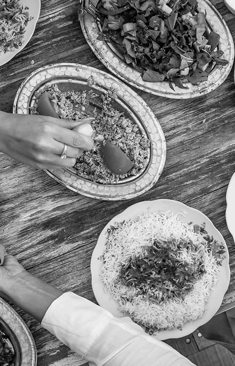 People sharing a selection of Emirati dishes around a table
